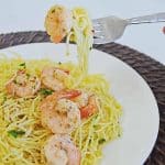 Shrimp Scampi pasta without white wine on a fork ready to be eaten.