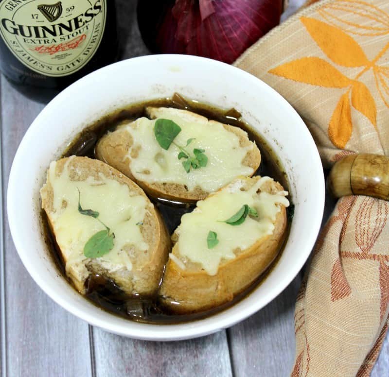 Crockpot French Onion Soup made with Guinness Beer and topped with toasted baguettes and Gruyere Cheese. 