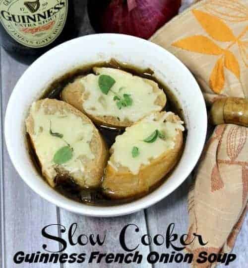 Slow Cooker French Onion Soup with Guinness in a bowl with bread and Gruyere cheese.