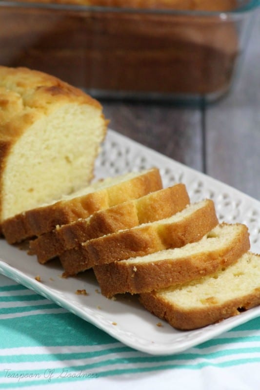 Easy Homemade Pound Cake sliced waiting to be topped with strawberry sauce