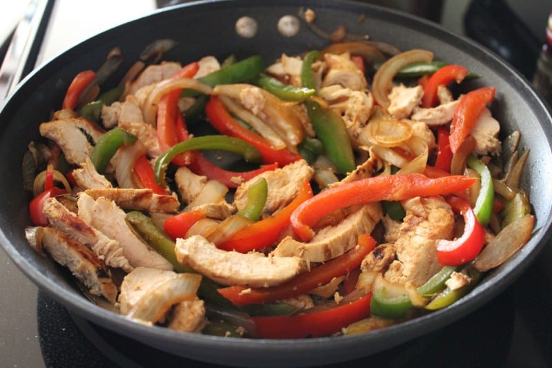 Easy Weeknight Chicken Fajitas sauteing in a pan. 