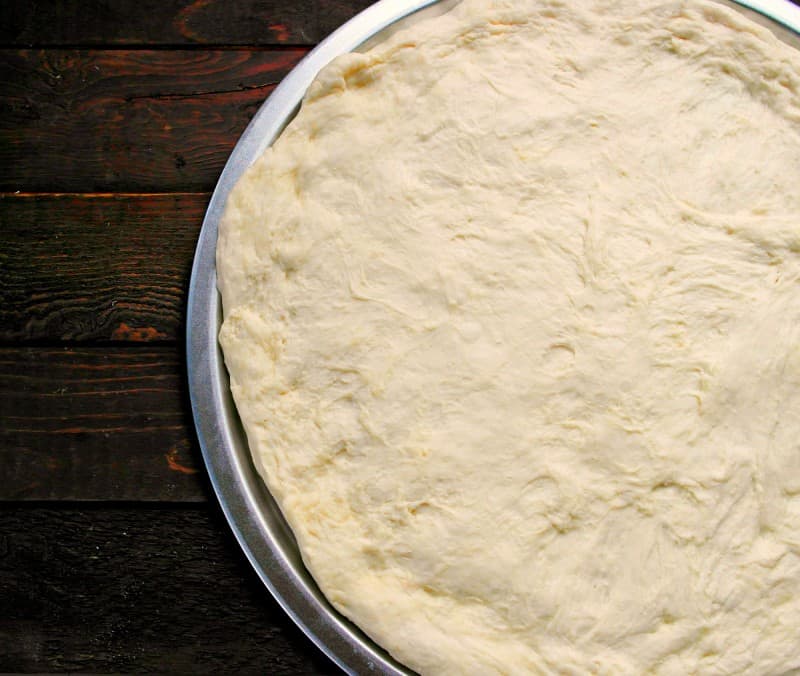 Everyone loves pizza, and this homemade Pizza Crust is a super easy way to make your own custom pizza at home. No need to order takeout from any of the local delivery places. Simply whip up this delicious dough in no time, and then you can top with your favorite pizza toppings. - Teaspoon Of Goodness