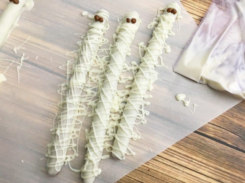 Dipped pretzel rod recipe decorated to look like Mummies for a fun Halloween treat. 