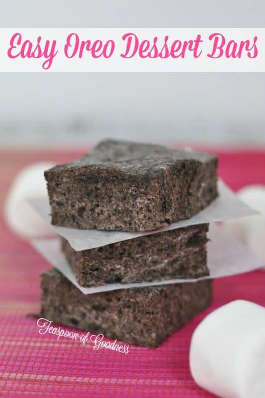 Easy Oreo Dessert Bars on a pink tablecloth with loose marshmallows. 