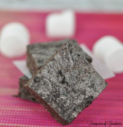 No Bake Oreo Dessert Bars cut into squares with marshmallows on a pink tablecloth 