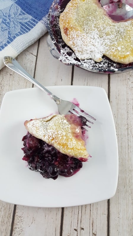 Rustic Blueberry Tart on a plate with a fork made with a simple blueberry filling recipe. 