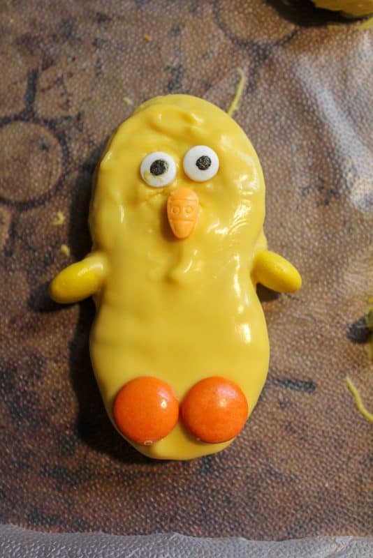 Nutter Butter Cookie dipped in yellow candy melts decorated as an Easter Chick for an Easter Treat