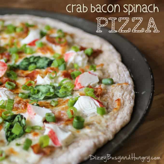 crab bacon and spinach pizza uncut on a baking dish