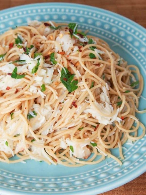 crab pasta with imitation crab meat on a blue plate