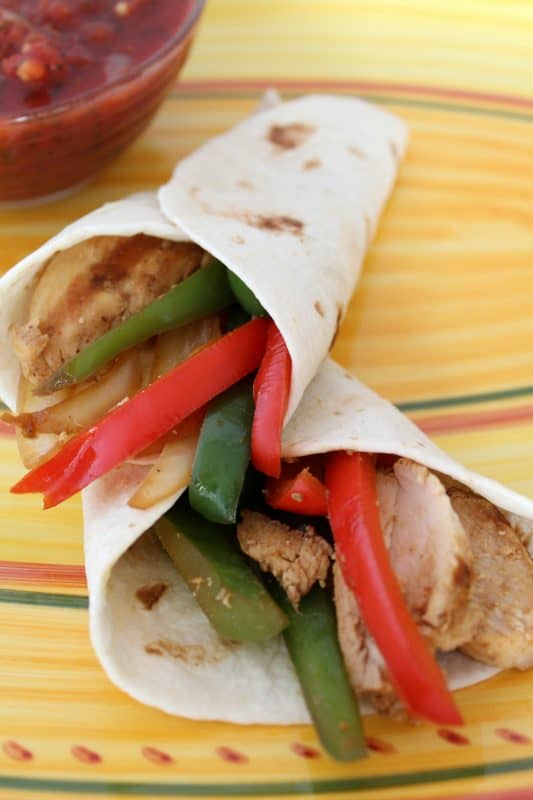 Easy Weeknight Chicken Fajitas in flour tortillas. 