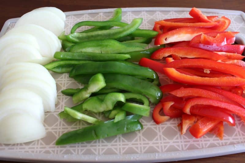 Red pepper, green pepper and onions sliced ready for simple chicken fajitas. 