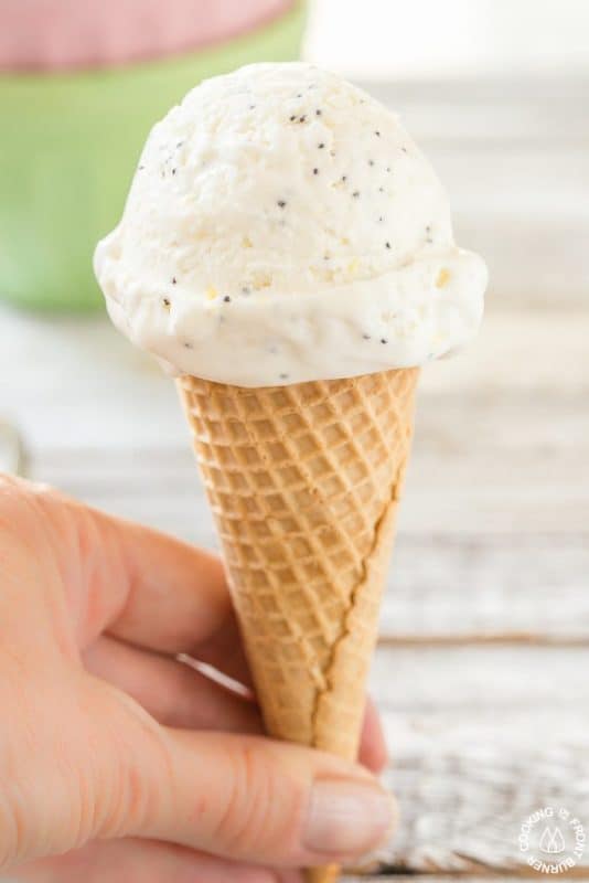 Lemon and poppy seed no churn ice cream in an ice cream cone. 