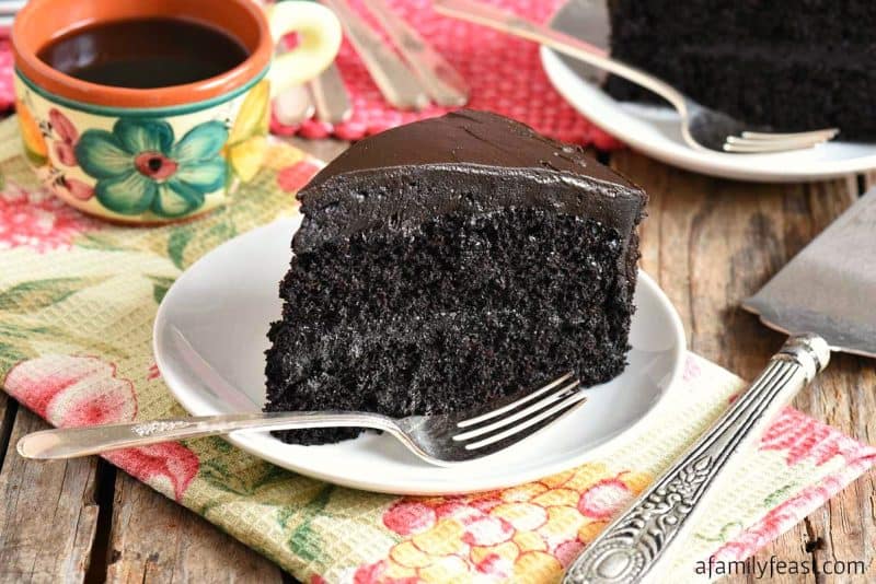 Double Chocolate Cake (black midnight cake) on a white plate for Mother's Day dessert. 