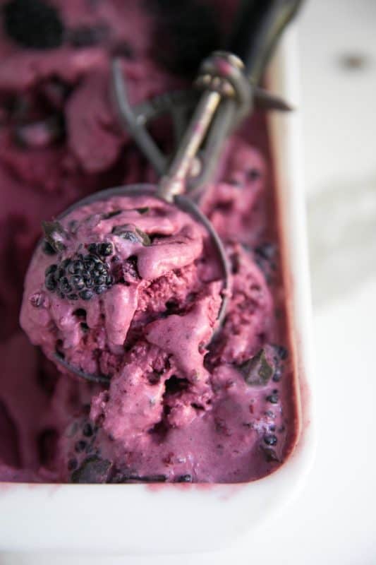 No churn blackberry chocolate ice cream in an ice cream scoop. 