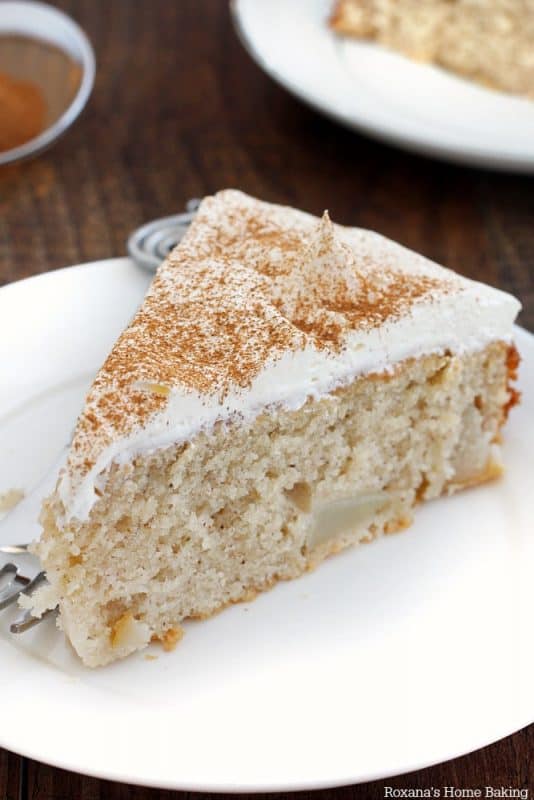 A slice of cinnamon pear cake on a white plate for a Mother's Day Brunch. 