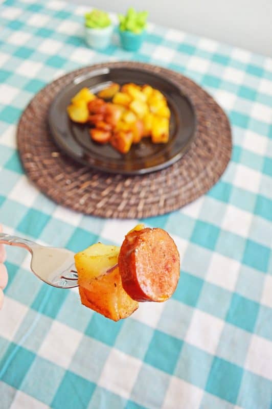 Sausage and potato on a silver fork