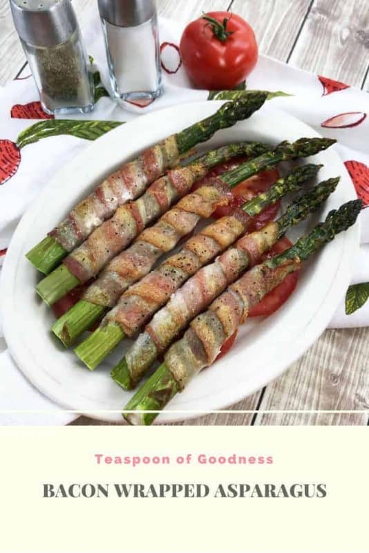 Oval white bowl with Asparagus wrapped bacon in the bowl 