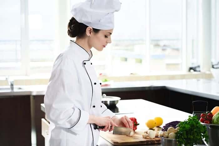 Woman chef cutting ingredients