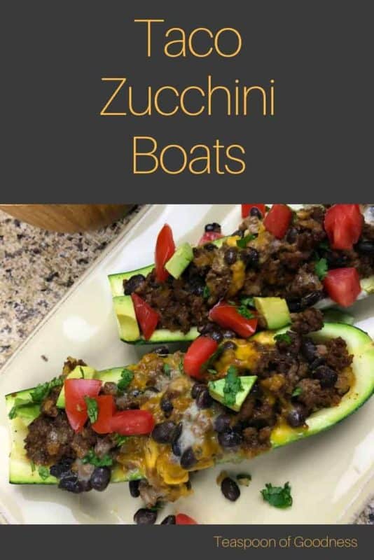 Zucchini with meat and vegetables in it on a white plate