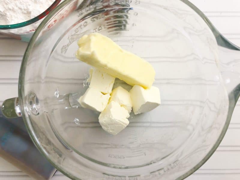 Butter and cream cheese in a bowl to make the best tasting cream cheese frosting.