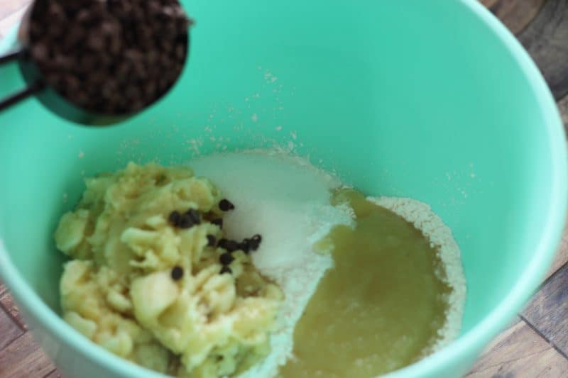 Ingredients for banana muffins with chocolate chips in a mixing bowl.