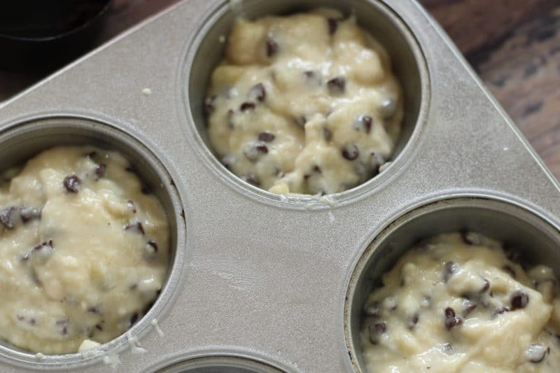 Banana muffins with chocolate chips in a muffin tin.