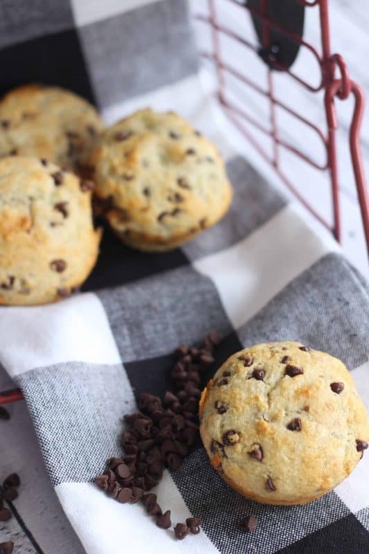 Banana muffins on a black and white checked tablecloth.