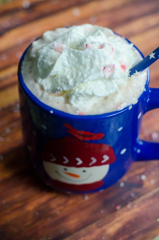 Homemade peppermint hot chocolate in a blue mug with a snowman on it. 