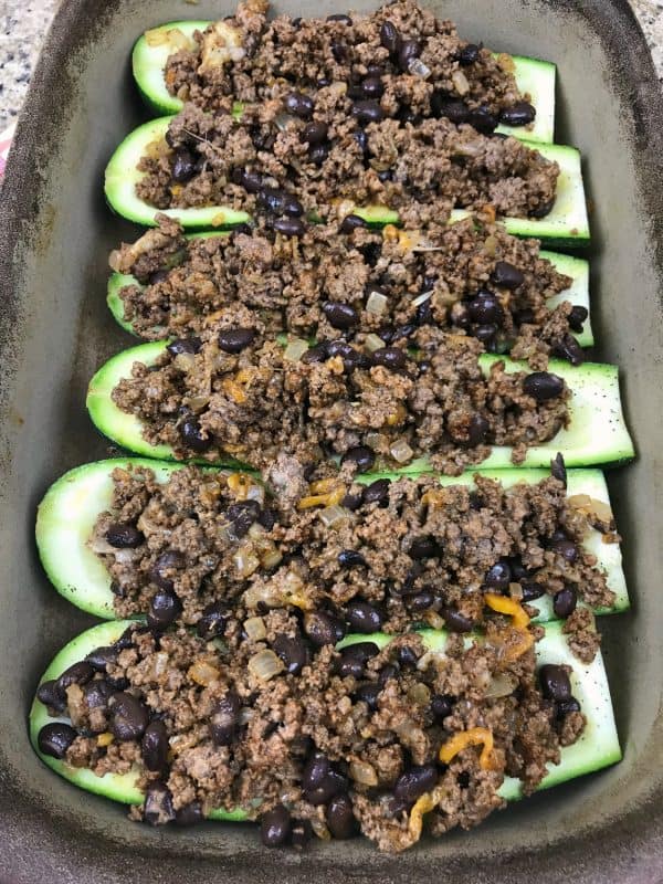 Zucchini taco boats on a baking sheet.