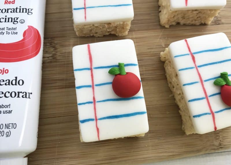 Premade rice crispy treats decorated like notebook paper. 