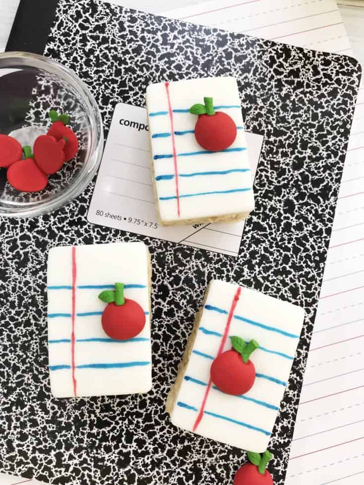 Premade rice crispy treats decorated like notebook paper.